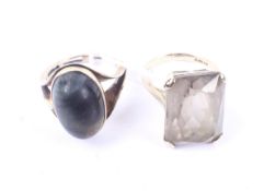 A South African oval cabochon 'hawks eye' single stone ring and a rectangular citrine single stone