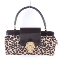 A Christian Louboutin (Paris) leopard print clutch handbag,