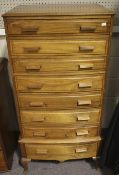A vintage mahogany tall boy chest of drawers.