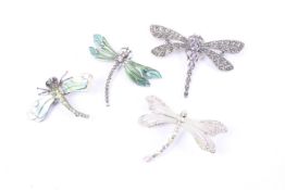 A collection of four silver dragonfly brooches including amethyst