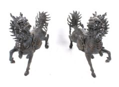 A pair of Chinese bronze Qilin. Mythological dragon horse creatures.