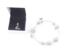 A modern silver (975) charm bracelet with various charms and a Pandora boxed spare charm