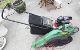 A Husqvarna Sovereign petrol lawn mower & a garden vac blower.