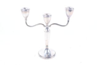 A silver two-branch/three light round candelabrum.