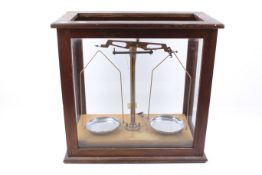A vintage cased set of science laboratory balance weighing scales.