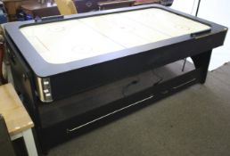 A 2 in 1 air hockey and pool table. With an adjustable height mechanism, H79.5cm x W216cm x D114.