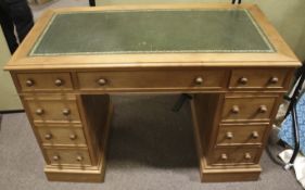 A contemporary pne pedestal desk. With inset green and gilt top, over two pedestals of four drawers.