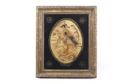 An 18th century embroidered picture. Depicting a goldfinch perched on a branch.