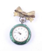 A ladies silver and enamel fob watch with gilt bow brooch