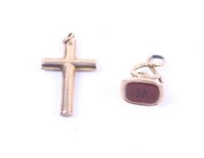 An early 20th century rose gold Latin cross and a fob seal.