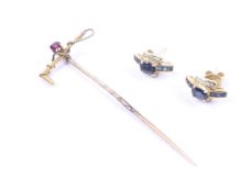 An early 20th century gold and garnet single stone riding crop stick pin and earrings.