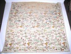 A length of fabric decorated with crewelwork.
