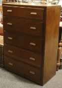 A mid-century tall chest of shallow drawers.