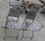Two folding metal garden chairs.
