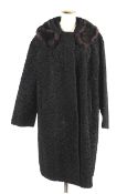 A vintage Astrakhan fur coat with a mink fur collar.