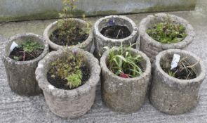 Seven round reconstituted stone garden planters.