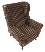 A Parker Knoll style wing back armchair.