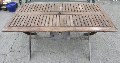 A rectangular teak garden table.