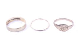 Two 9ct gold wedding bands and a child's signet ring.
