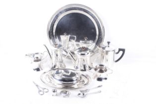 A collection of silver-plate including a beaded round tray with an engraved Greek-key band.