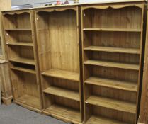 Three contemporary pine bookcases. Each with five adjustable shelves, raised on a plinth base.