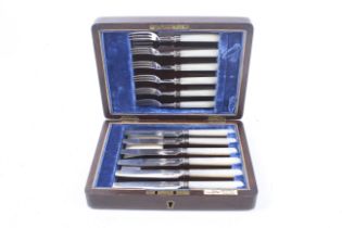 A set of six silver and mother of pearl handled tea knives.