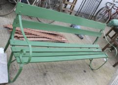 Green painted garden bench. With wrought metal ends.