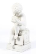 A Parian ware figure of a child writing.
