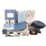 A collection of WWII and later items and manuals in a suitcase.