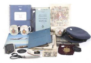 A collection of WWII and later items and manuals in a suitcase.