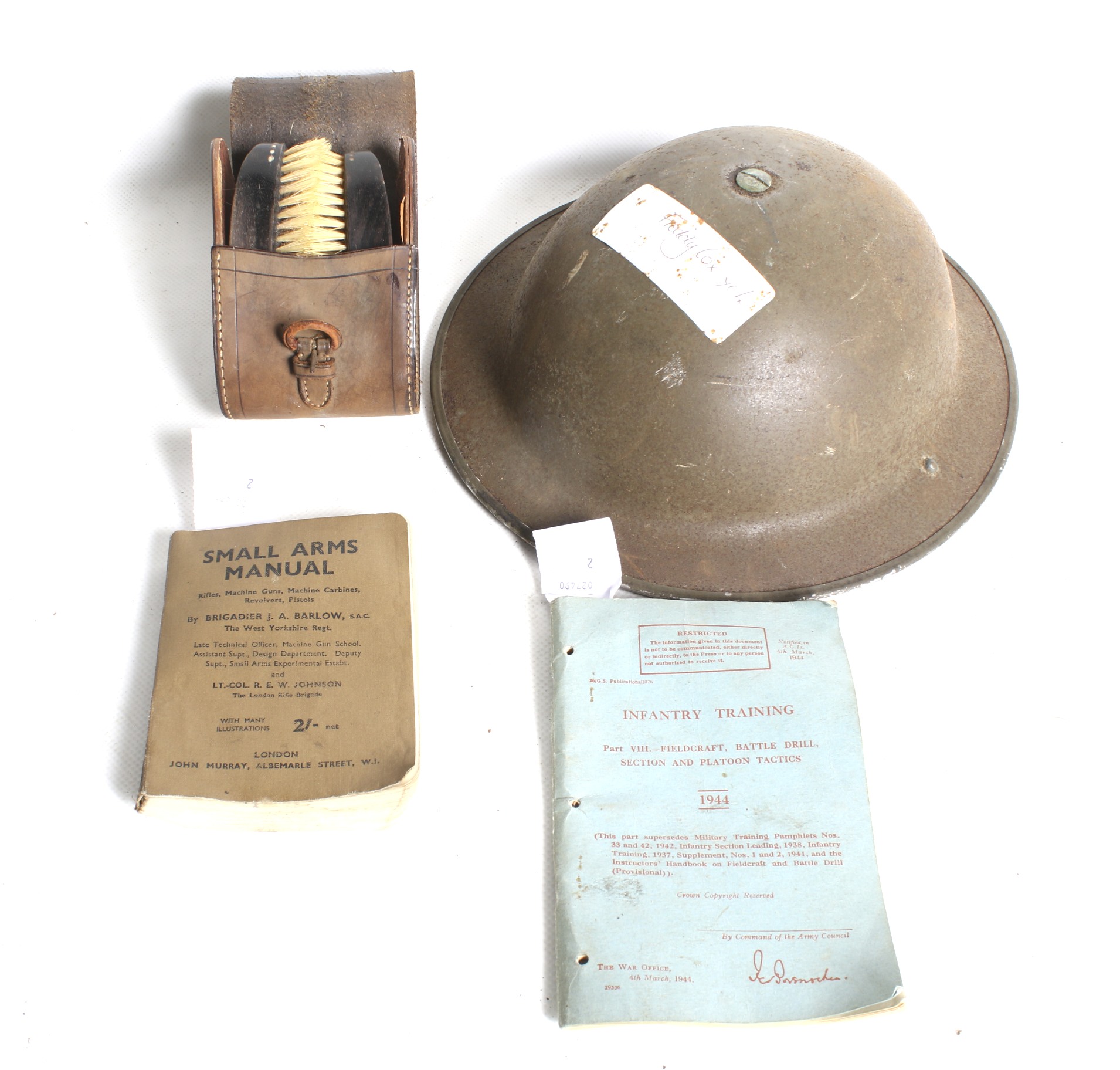 A WWII helmet, brushes and box belonging to the Cox family.