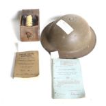 A WWII helmet, brushes and box belonging to the Cox family.