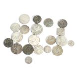 A collection of twenty Indian coins. Including Mughal Rupees and half Rupees.