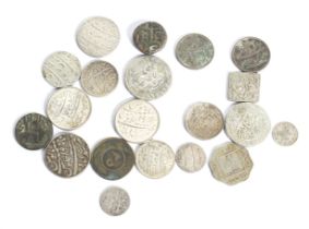 A collection of twenty Indian coins. Including Mughal Rupees and half Rupees.