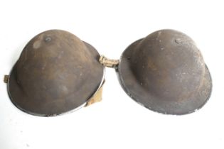 Two WWII Brodie helmets.