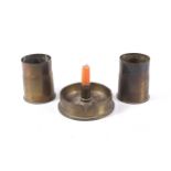 Three Trench Art shell cases in the form of two short vessels and a candlestick holder.
