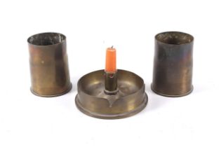 Three Trench Art shell cases in the form of two short vessels and a candlestick holder.