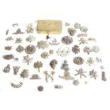 A large quantity of military cap badges and a Princess Mary gift box.