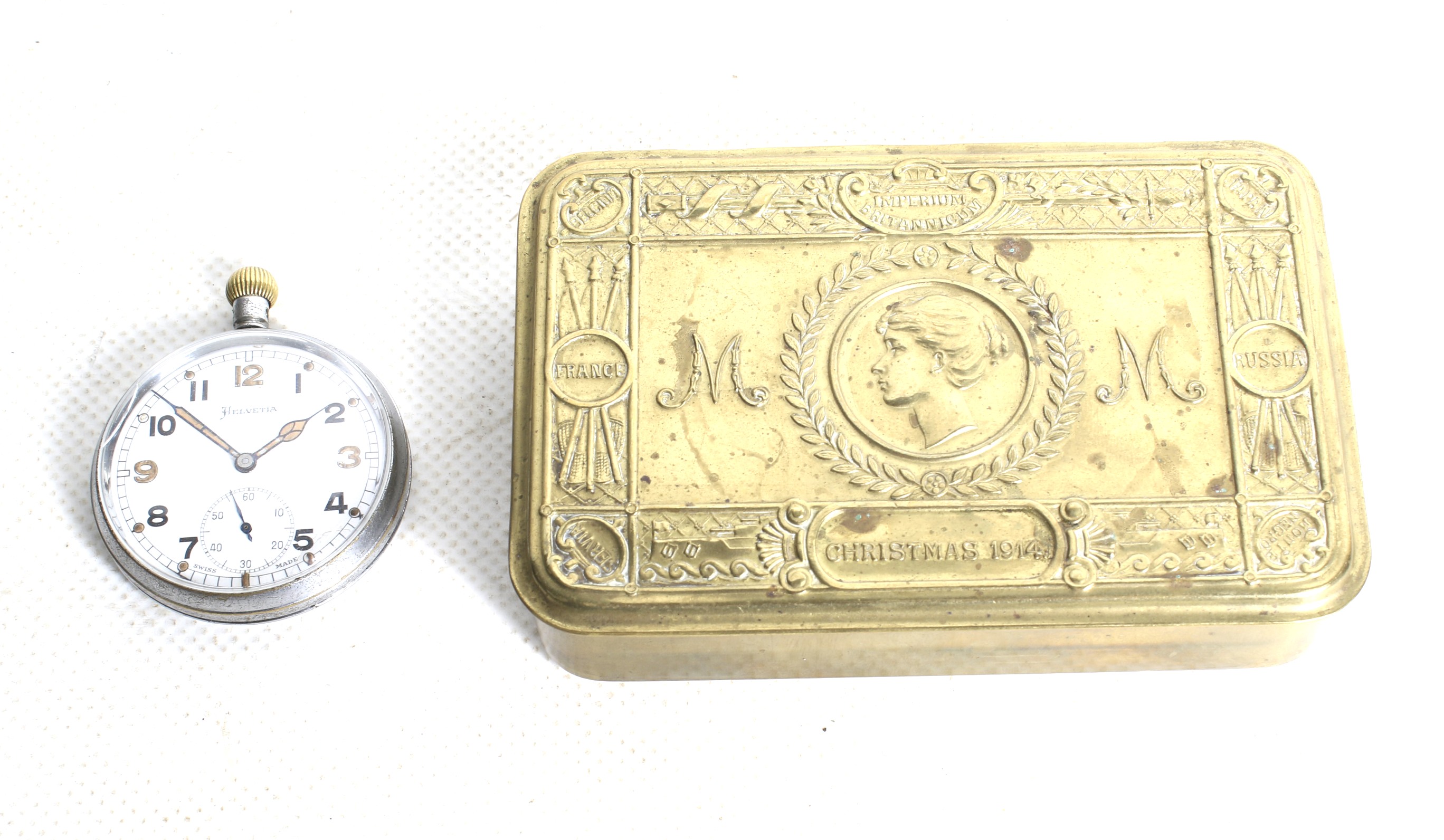 A 1914 Princess Mary Christmas tin and a WWII British military pocket watch.