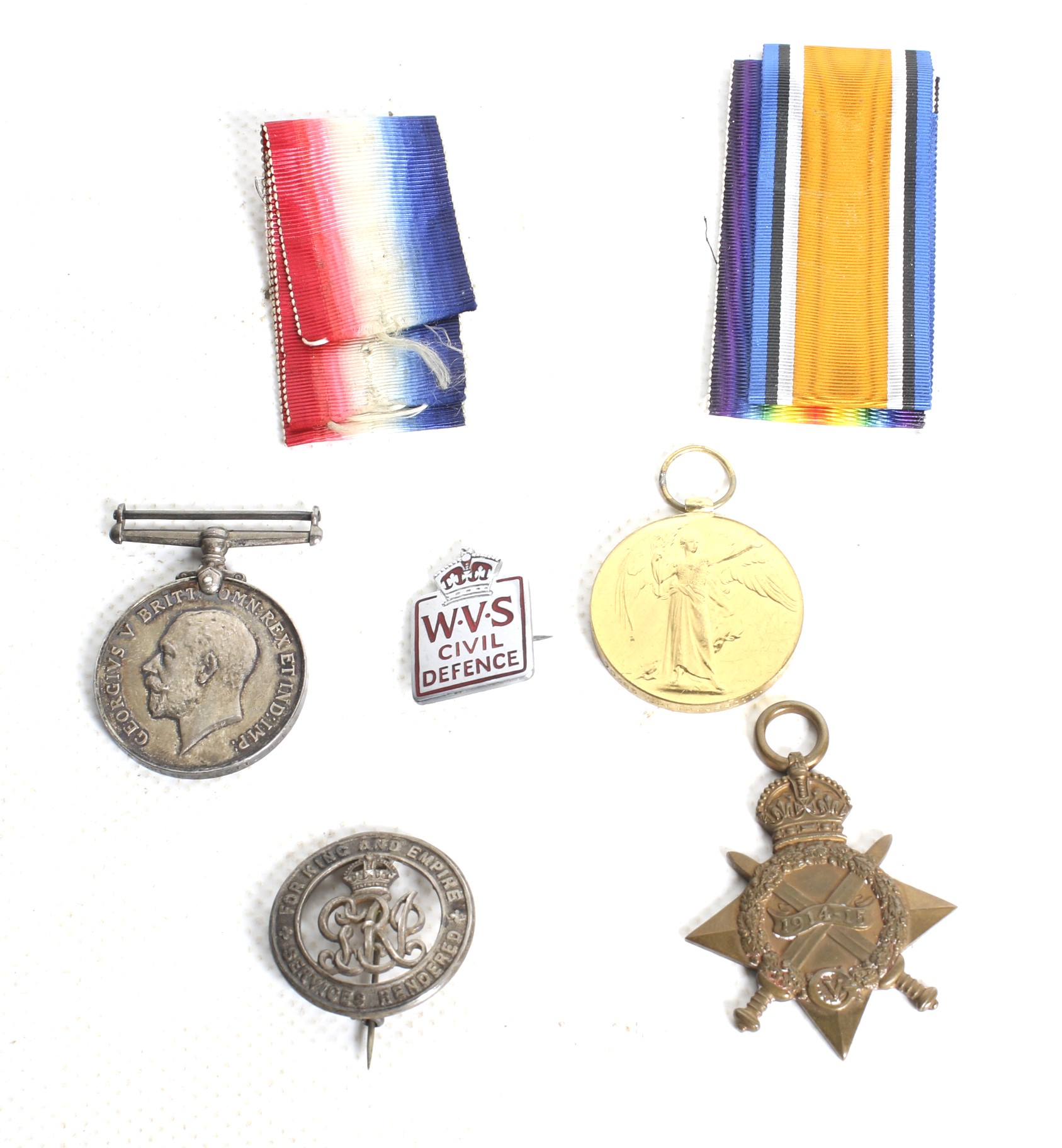 A set of three WWI medals and three badges.