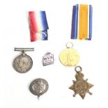 A set of three WWI medals and three badges.