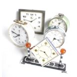 A collection of five assorted mid-century alarm clocks.