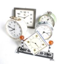 A collection of five assorted mid-century alarm clocks.