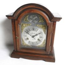 A Lincoln 31 Day 'Tempus Fugit' wood cased mantel clock. With an arched top.