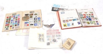 A collection of mixed World stamps and cigarette trading silks..