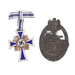 A WWII German military bronze tank badge, and an enamel Mother's Cross medal.