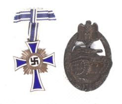 A WWII German military bronze tank badge, and an enamel Mother's Cross medal.