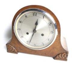 A circa 1930s English oak cased striking mantel clock. Eight day movement, striking to a gong.