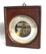 A cased aneroid wall barometer and thermometer.