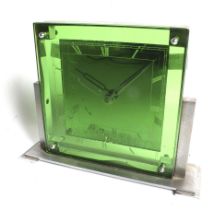 An Art Deco style square dial mantel clock with green glass. Chrome stepped plinth.